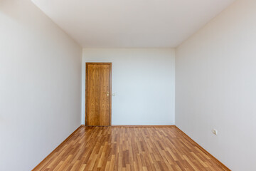 Empty bright living room. New home interior. Wooden floor.