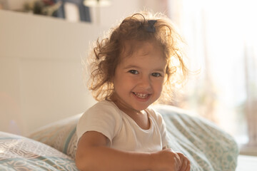 Fototapeta premium Cute child girl enjoys sunny morning. Good morning at home.