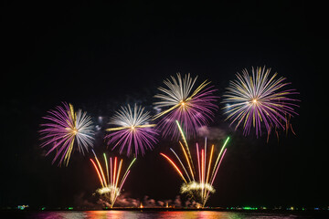 Colorful fireworks of various colors at night with celebration and anniversary concept