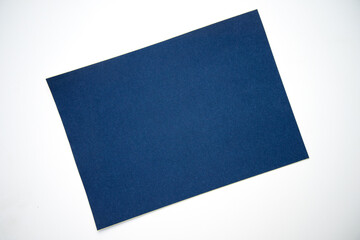 A blue sheet of craft cardboard on a white isolate. Blue cardboard sheet, background for text.