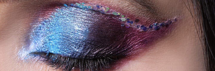 Closeup of closed eye with bright shiny shadows