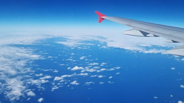 flight. wing of the aircraft in flight from the window of the aircraft above ground. air travel. comfort and speed of travel by plane. promotions and discounts on tickets.