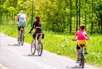 Cyclists ride on the bike path in the city Park
