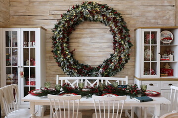 a garland of branches of a Christmas tree decorated for the new year at the dining table
