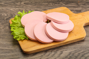 Sliced sausage snak over board © Andrei Starostin