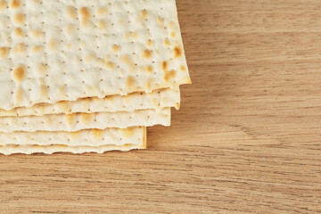 Religious Jewish matzah for the Jewish holiday of Passover on a wooden table