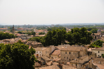 Obraz premium Tiled red roofs of the old town of Avignon, France. Hot summer afternoon. Top view. 