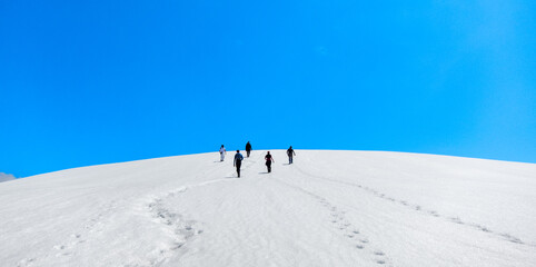 Fototapeta na wymiar group of hikers, snowy hills