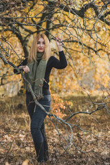 Fashionable details, women's outfits. Lady in black total look with green scarf 