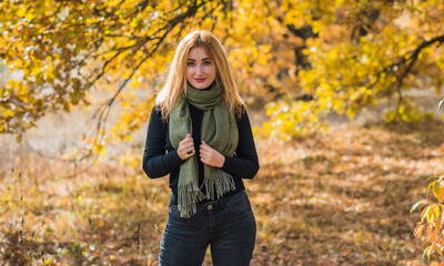 Fashionable details, women's outfits. Lady in black total look with green scarf 