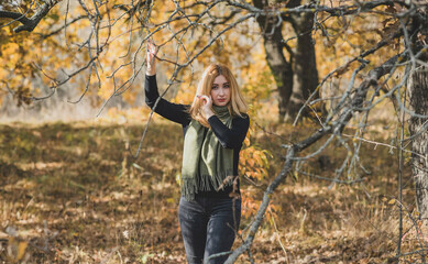 Fashionable details, women's outfits. Lady in black total look with green scarf 