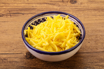 Shredded yellow cheese in the bowl