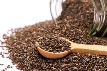 glass can full of organic natural chia seeds close-up isolated on white background