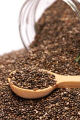 glass can full of organic natural chia seeds close-up isolated on white background