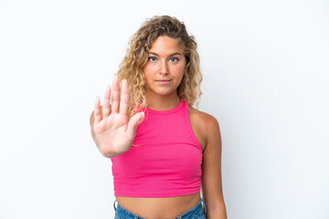 Girl with curly hair isolated on white background making stop gesture