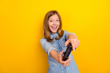 Photo of hooray little brown hairdo girl playstation wear denim shirt isolated on bright yellow color background