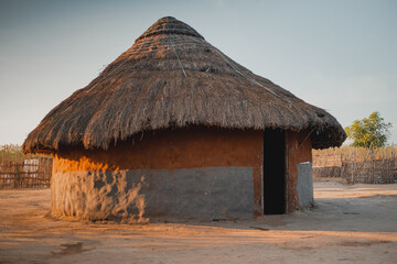 an earthen village house in the african countryside - obrazy, fototapety, plakaty