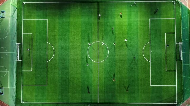 Drone video, aerial shot, soccer field, pursuing, green, lawn.