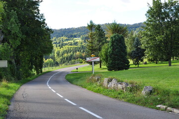 The road in the forest of France. Travel to France. The road among the mountains