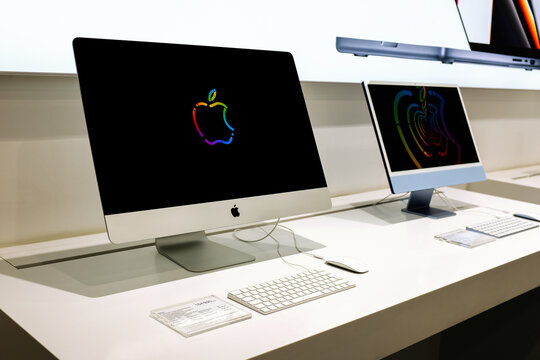 Apple iMacs in Apple store. Editorial illusrative photo of new Apple 27-inch(Retina 5K display) and 24-inch(M1 chip) iMacs