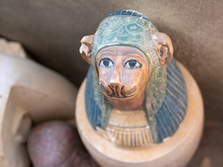Close-up of a stone statuette of an Egyptian deity with an animal head. Selective focus. Luxor, Egypt.