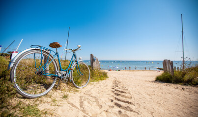 Fototapeta na wymiar Bord de mer et vieux vélo bleu sur le littoral vendéen, île de Noirmoutier en France.
