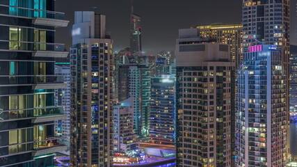 Fototapeta na wymiar Dubai Marina Skyline with JLT district skyscrapers on a background aerial night timelapse.
