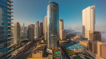 Panoramic view of the Dubai Marina and JBR area and the famous Ferris Wheel aerial morning timelapse