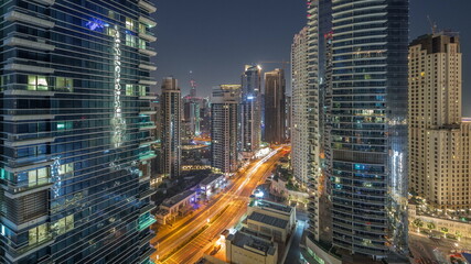 Fototapeta na wymiar View of the Dubai Marina and JBR area and the famous Ferris Wheel aerial night to day timelapse