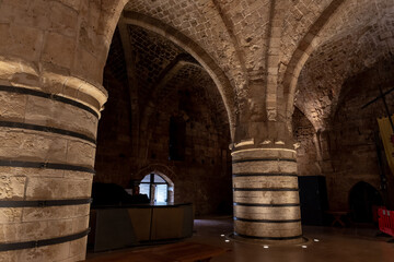 Fototapeta na wymiar Reconstructed large stone dining room in the Crusader fortress of the old city of Acre in northern Israel