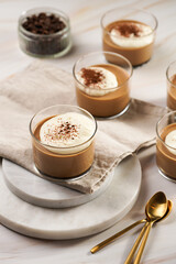 Italian chocolate and coffee mousse dessert semifreddo - half-frozen ice cream with whipped cream and cocoa powder in small glasses