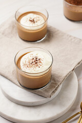 Italian chocolate and coffee mousse dessert semifreddo - half-frozen ice cream with whipped cream and cocoa powder in small glasses