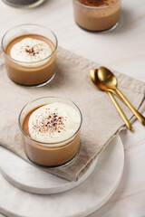 Italian chocolate and coffee mousse dessert semifreddo - half-frozen ice cream with whipped cream and cocoa powder in small glasses