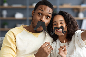 Funny african american father and daughter taking selfies