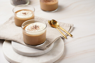 Italian chocolate and coffee mousse dessert semifreddo - half-frozen ice cream with whipped cream and cocoa powder in small glasses