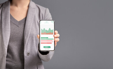 Cropped of business woman showing financial app on smartphone