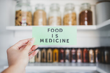 Food is Medicine text in front of tidy organised pantry with jars, dieting vs healthy nutrition and...