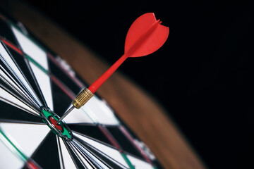Concept achieving goal .Achieving goals in business and life.Dartboard with darts stuck right in center of target.