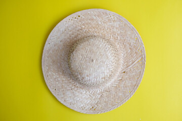 Fototapeta na wymiar Women's sun hats against a yellow background, beach fashion
