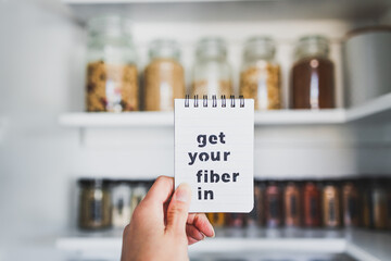 Get Your Fiber In text in front of tidy organised pantry with jars lined up on shelves, dieting vs...
