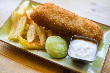Fish and chips with tartar sauce on a plate