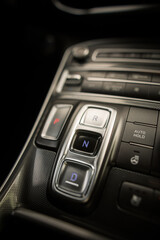 Obraz premium Automatic button gear shifter in a new car