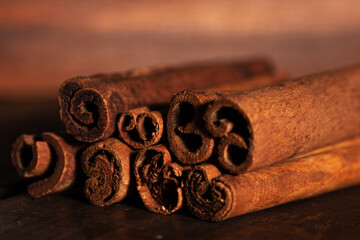 cinnamon and cassia sticks are close. brown condiment sticks on the side