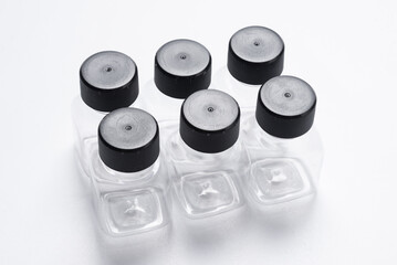 Set of transparent plastic bottles, empty, on white desk