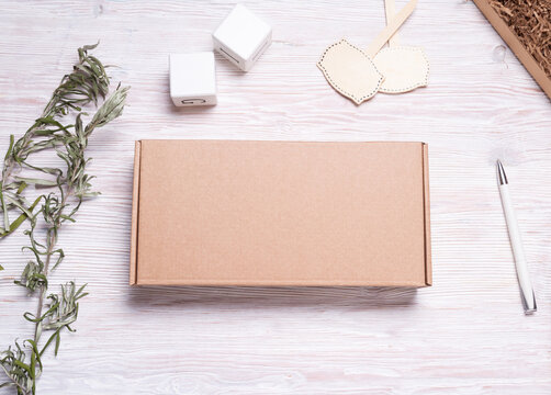 Brown carton cardboard box, on wooden table