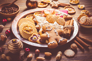 Variation of Christmas cookies, gingerbread man and nuts with candle and ornaments