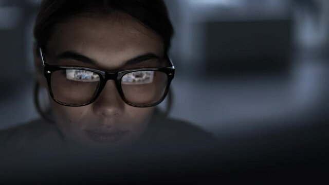 Young woman working computer long hours
