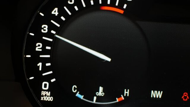 The digital tachometer arrow on the dashboard of a modern car close-up
