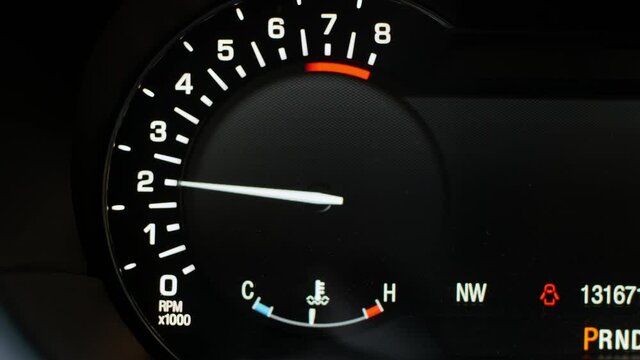 The digital tachometer arrow on the dashboard of a modern car