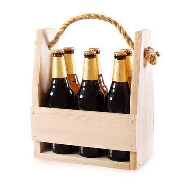 Beer bottles in a wooden beer crate isolated on white background.